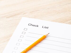 Checklist sheet with pencil on a wooden desk